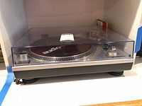 Audio-Technica turntable in cabinet with dust cover closed