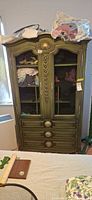 Full view of green French Provincial wardrobe armoire with mesh doors and drawers