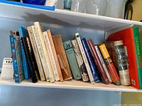 Full shelf showing majority of the cookbook lot