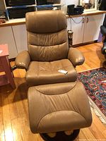 Front view of leather swivel recliner and ottoman
