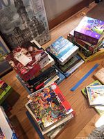 Multiple stacks of assorted jigsaw puzzle boxes