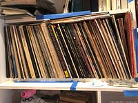 Shelf box containing row of vinyl LPs with visible spines