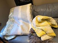 King patchwork quilt draped over sofa with tag visible