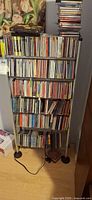 Full view of CD rack filled with CDs showing overall quantity and rack design