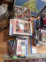 Stack of puzzle and block boxes on floor