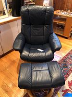 Front view of blue leather recliner and ottoman