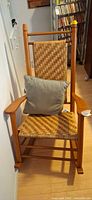 Full front view of maple/oak rocking chair with woven seat and backrest
