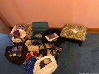 Group of yarn, bags, plastic case with sewing supplies, footstool