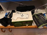 Overall lot showing Tivoli radio, Ion cassette converter box, remote, antenna and cables