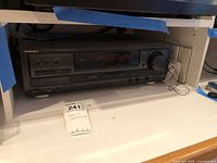 Front view of Technics receiver inside shelf