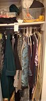 Closet rod with numerous women’s garments on hangers