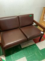 Full view of loveseat showing frame and cushions