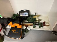 Shelf with weight plates, bars, tool case and screwdriver