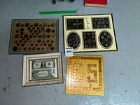 Four framed coin and currency displays on floor