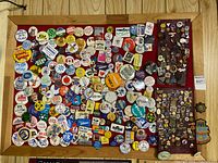 Full cork board showing large collection of buttons and pins
