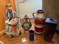 Group shot of statue, decanter and three vases