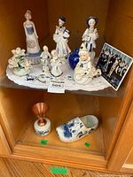 Overall view of Delft figurines, clog, goblet and decor items on shelf