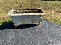 Full view of rectangular cast iron planter showing overall design and condition