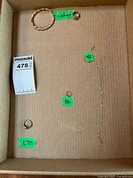 Overview of all four jewelry pieces laid in carton