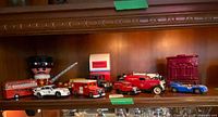 Group of die-cast vehicles on shelf