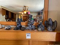 Group shot of all carvings and stones on shelf