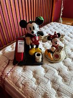 Front view of both Disney character telephones