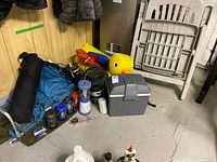 Overall view showing folding chair, inflatable duck, cooler, backpack, lantern, cookware, drinkware