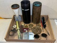 Overall tray view with plaque, ordnance pieces, badges and accessories