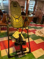 Full view of Teeter inversion table front with manuals hanging