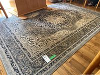 Full view of the rectangular oriental area rug on hardwood floor