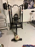 Front view of York leverage bench press with leg developer and weight plates installed