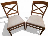 Two Pottery Barn X-back dining chairs side by side showing overall design and condition