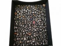 Tray filled with assorted metal charms