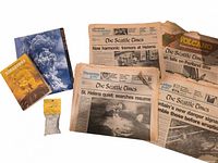 Lot overview showing newspapers, two books and pumice bag
