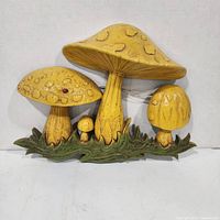 Front view of yellow mushroom wall plaque