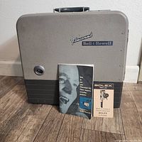 Front view of Bell & Howell Filmosound 202 projector carry case with manuals