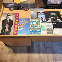 Top-down view of table showing assortment of posters, photograph, flyers and magazines