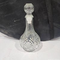 Front view of cut lead crystal decanter with stopper showing overall form and pattern