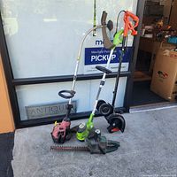 Group shot of hedge trimmer, two string trimmers and edger