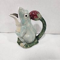 Three-quarter front view of ceramic frog pitcher