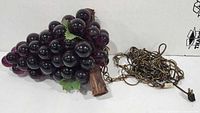 Entire lamp showing Lucite grape cluster, wood stem and attached chain with plug