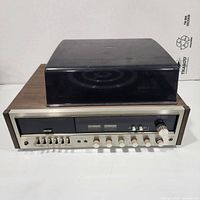 Front view showing cassette deck, tuner controls, wood cabinet