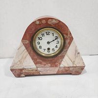 front view of marble mantel clock showing dial and marble pattern