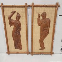 Both carved wood dancer panels side by side