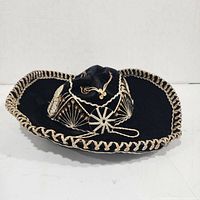 Top view of black velvet sombrero showing embroidery and braided edge