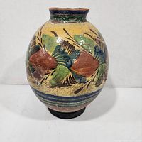 front view of crackle-glazed vase showing painted motif