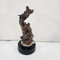 Front view of dragon lighter showing sculptural detail and base