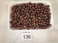 Tray filled with numerous pink floral cloisonné beads