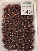 Tray showing large quantity of identical rose-pink lampwork beads