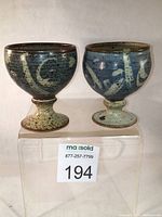 Both goblets front view on clear stand